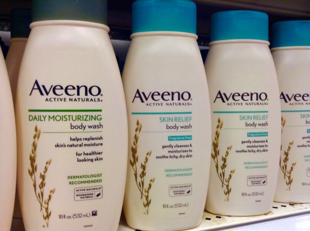 three bottles of shampoo, conditioner and cream from the Aveeno range