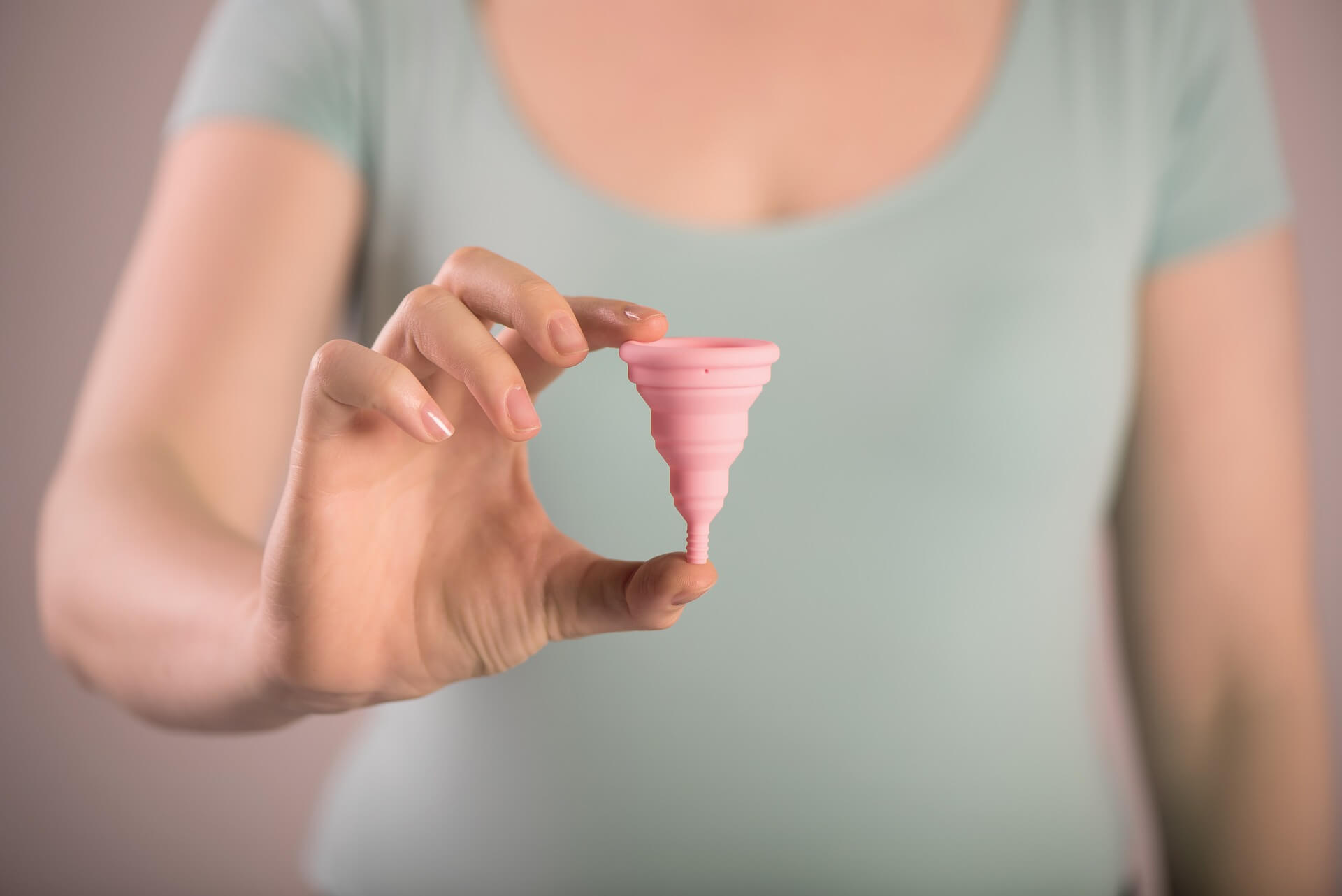 Hand holding a menstrual cup