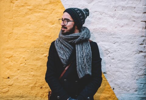 Man in glasses outside wearing a beanie hat and a scarf