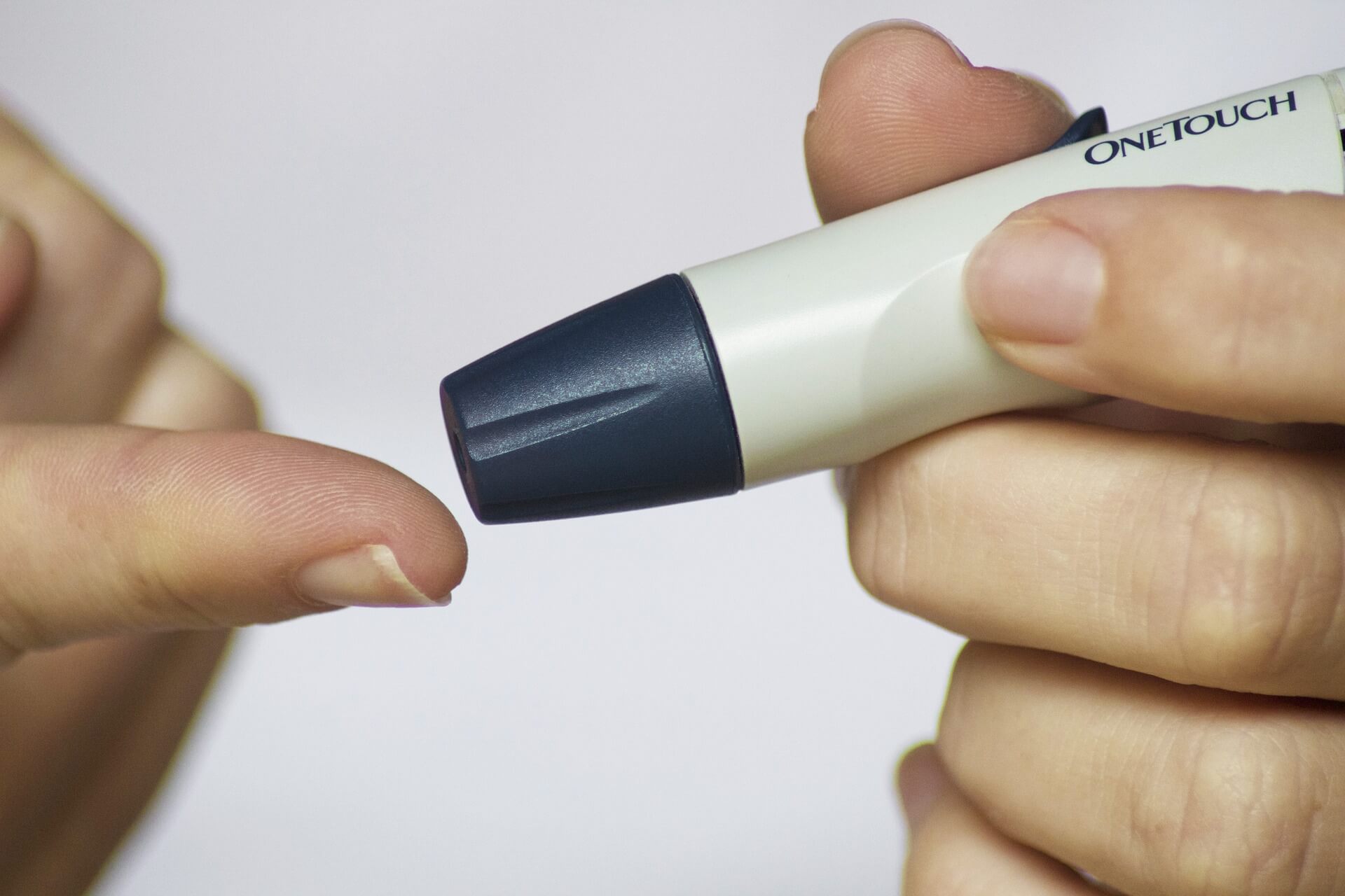 Person holding out their finger to have a finger-prick blood test