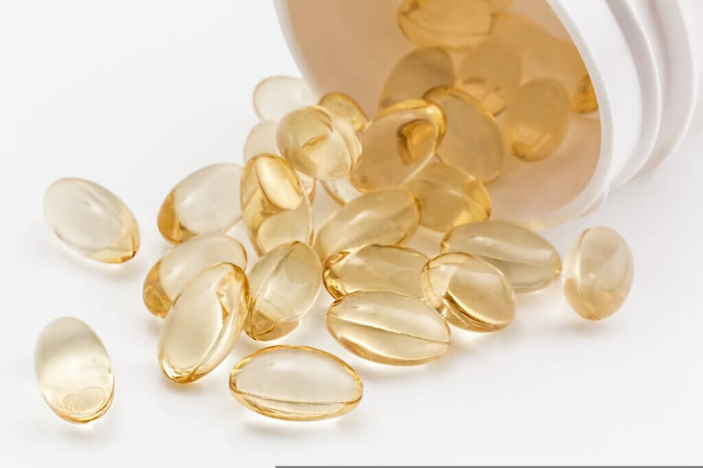 Supplements spilling out of a bottle.