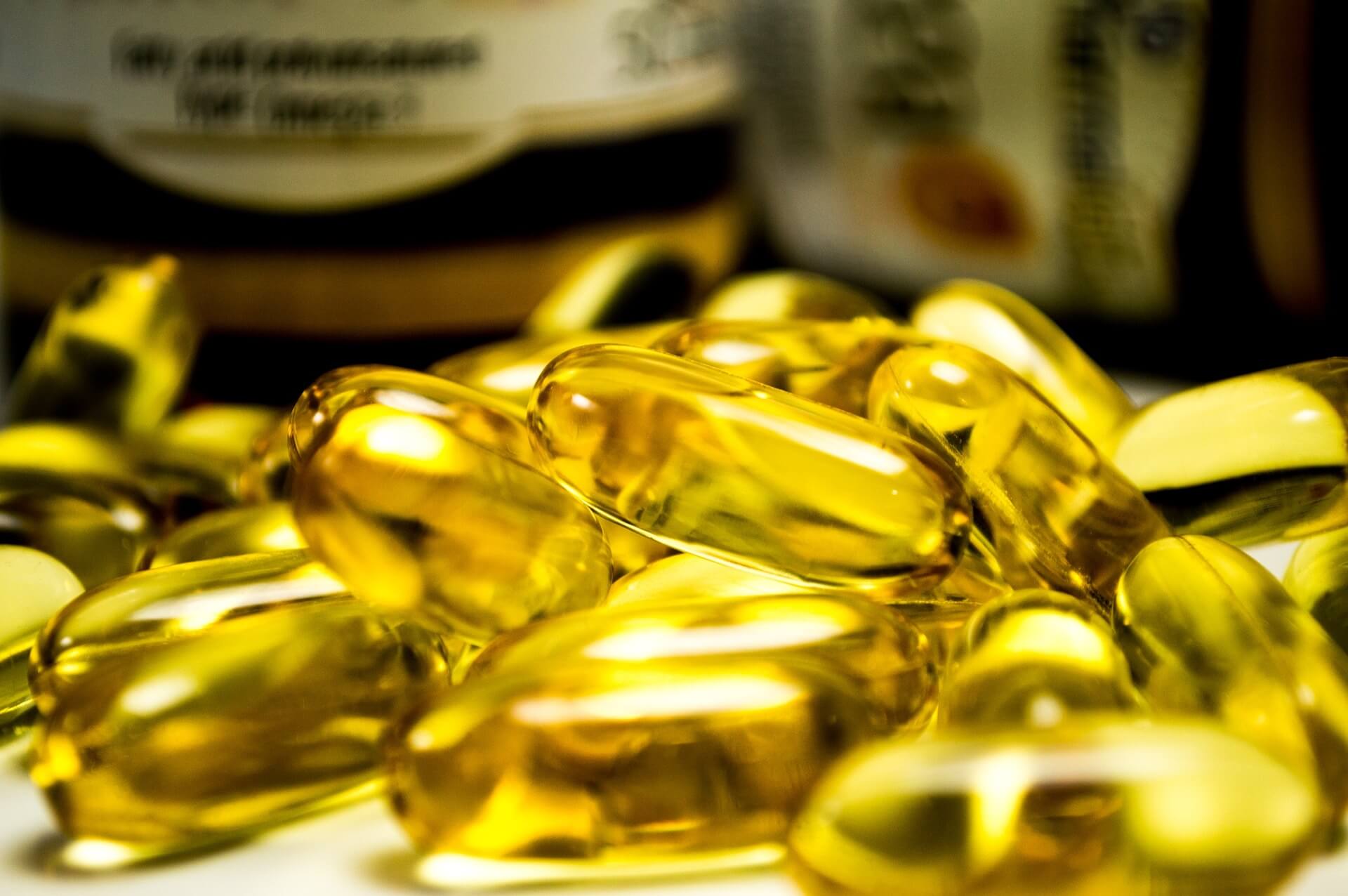 Yellow vitamin D softgel capsules.